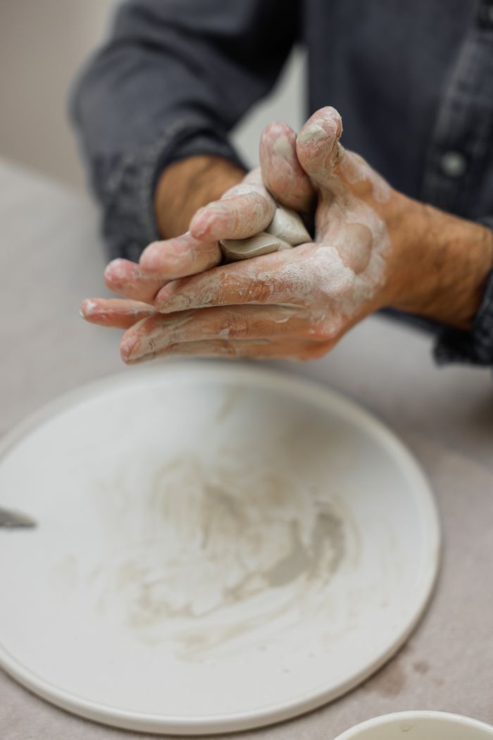 An artisan shaping handmade ceramics